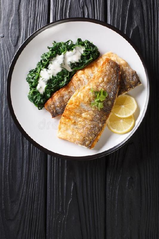 Roll of sea bass fish fillet with sauteed spinach-leek